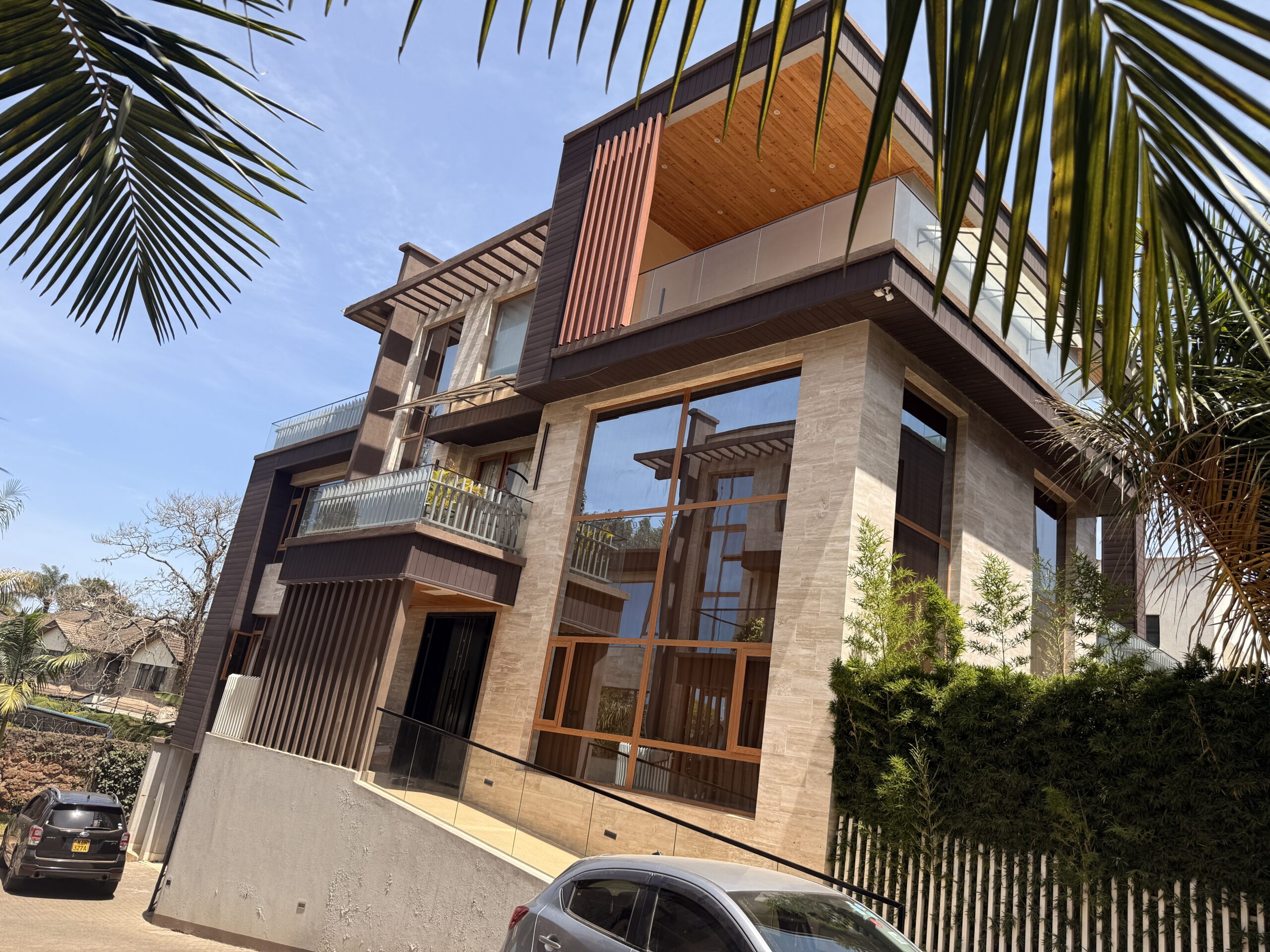 The stunning modern facade of Villa Lavendah Lavington featuring a secure double-door entrance and manicured gardens in a gated enclave.