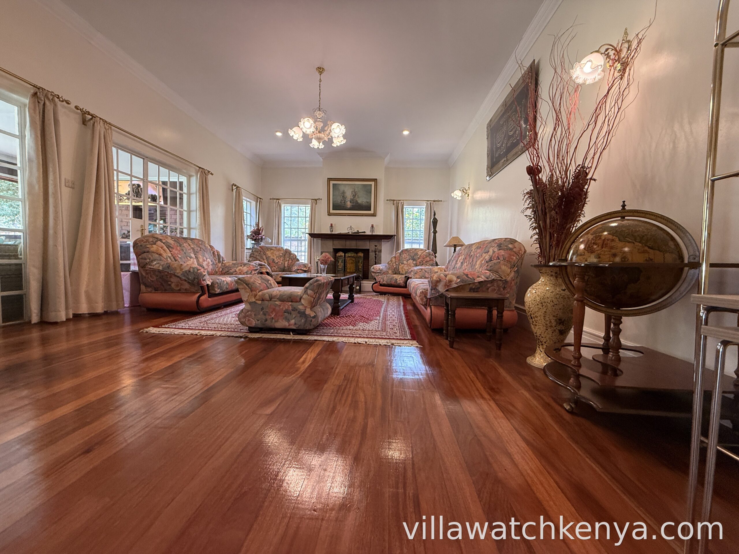 Spacious living room with sofas and natural light in 5-bedroom home on 1 acre Karen